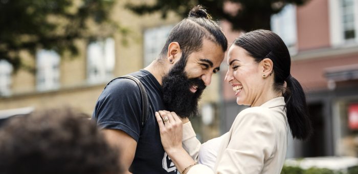 Happy couple outdoors laughing